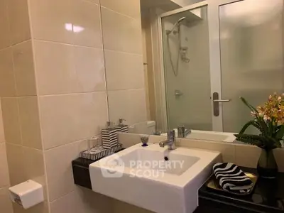Modern bathroom with sleek sink and glass shower enclosure