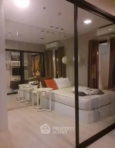 Modern bedroom with mirrored walls and cozy decor