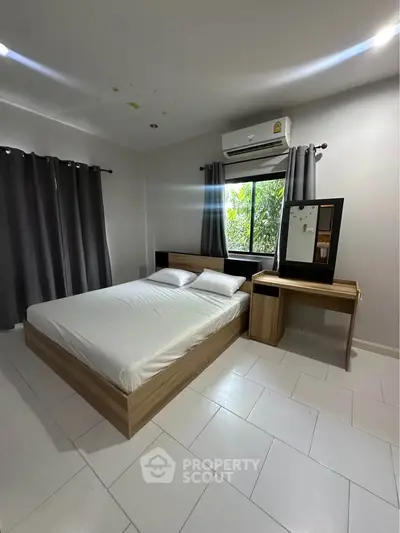 Modern minimalist bedroom with natural light and sleek furniture design.