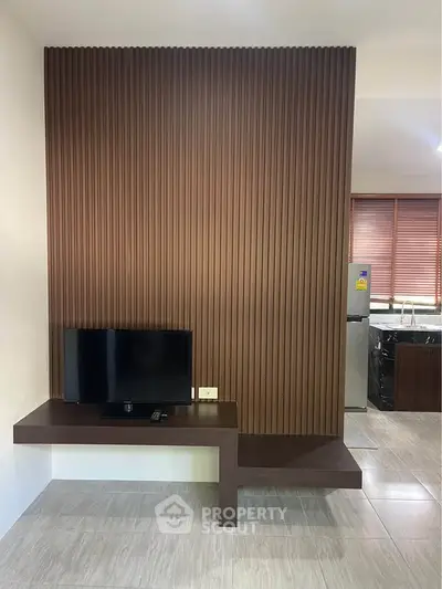 Modern living room with sleek TV stand and stylish wooden paneling