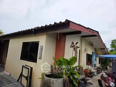 Charming single-story home with rustic brick accents and lush greenery