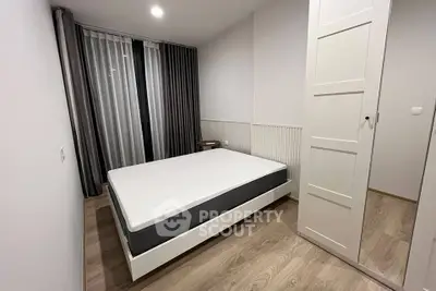 Modern minimalist bedroom with sleek design and ample natural light.