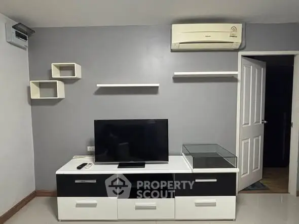 Modern living room with sleek TV stand and wall-mounted shelves