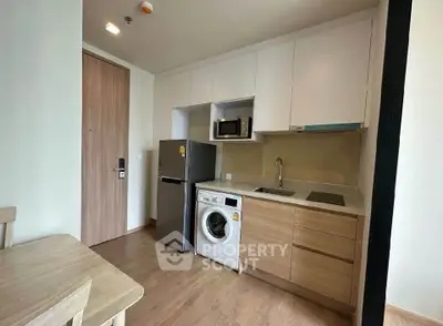 Modern compact kitchen with integrated appliances and wooden cabinetry