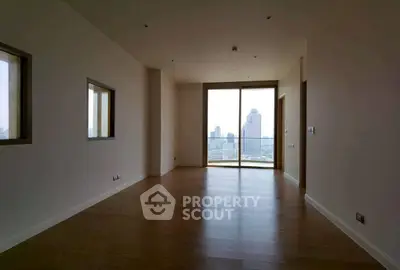 Spacious empty room with large windows and city view, perfect for customization.