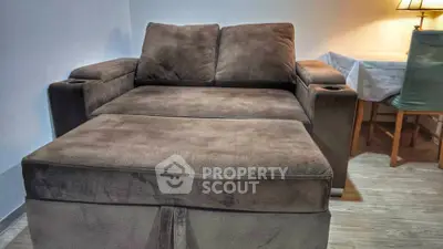Cozy living room with plush brown sofa and elegant table lamp
