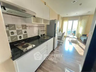 Modern kitchen with open layout and bright living area in stylish apartment