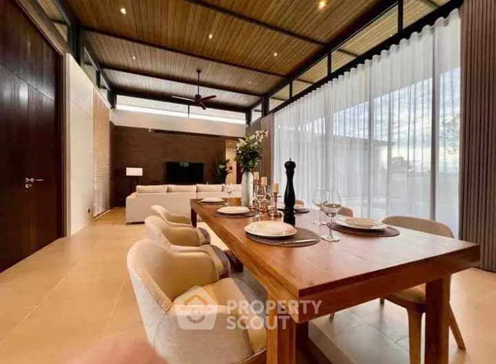 Luxurious open-plan living room with elegant dining area and modern decor