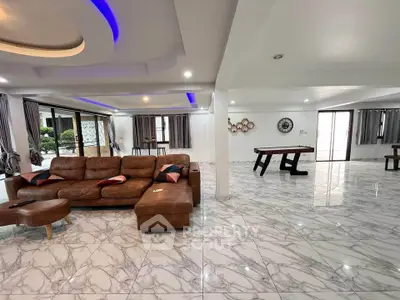 Spacious modern living room with luxurious marble flooring and stylish lighting