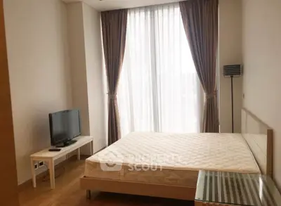 Bright bedroom with large window, modern furniture, and wooden flooring.