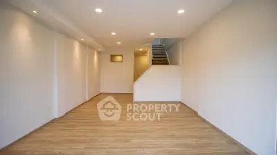 Spacious modern living room with wooden flooring and recessed lighting
