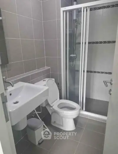 Modern bathroom with sleek shower and contemporary fixtures in a stylish apartment.