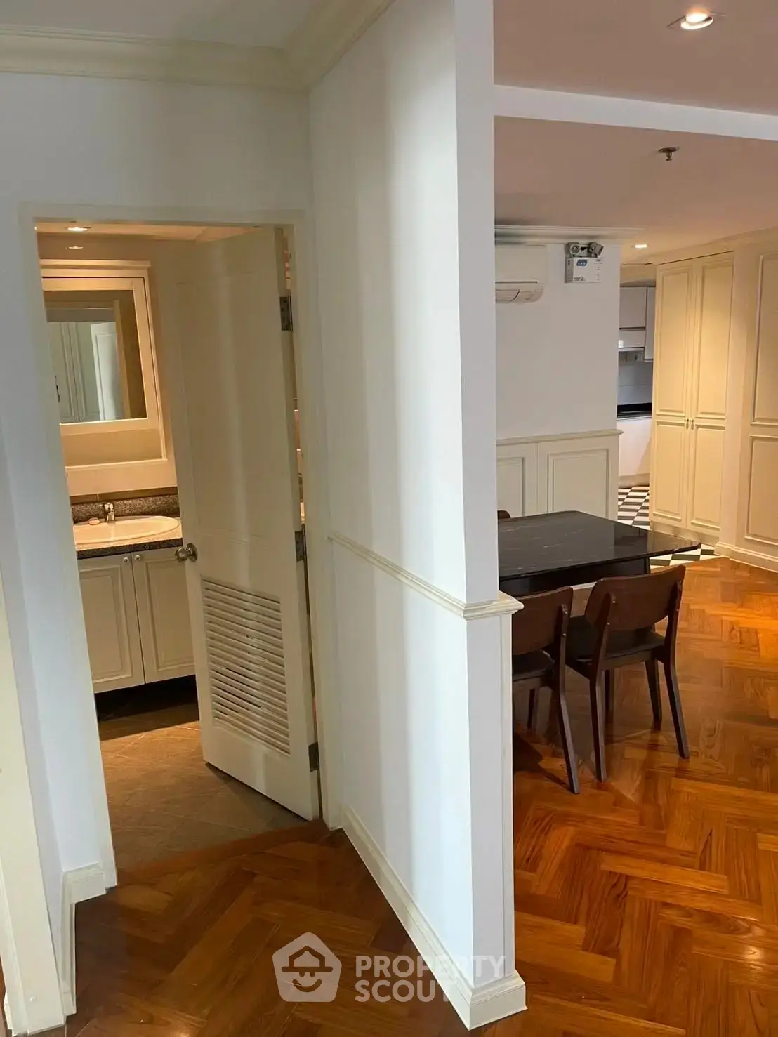 Charming apartment interior with elegant parquet flooring and cozy dining area