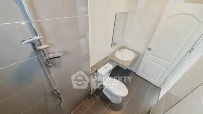 Modern bathroom with sleek fixtures and neutral tiles