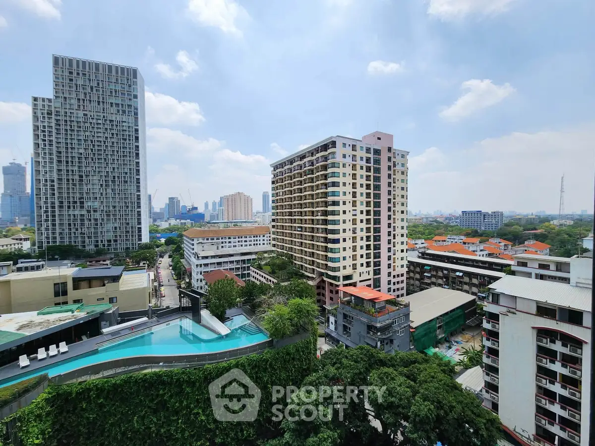 Stunning cityscape view with modern high-rise buildings and lush greenery, featuring a rooftop pool.