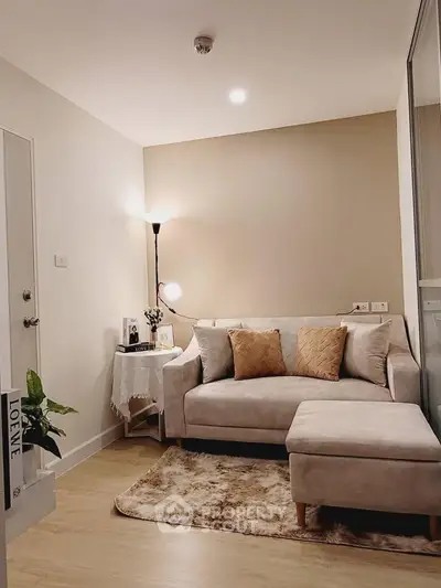 Cozy living room with plush sofa and warm lighting, perfect for relaxation.