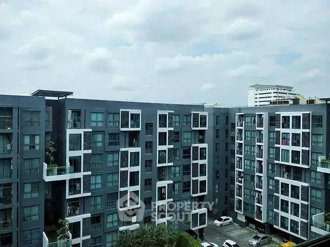 Modern apartment building with unique geometric facade and spacious balconies.