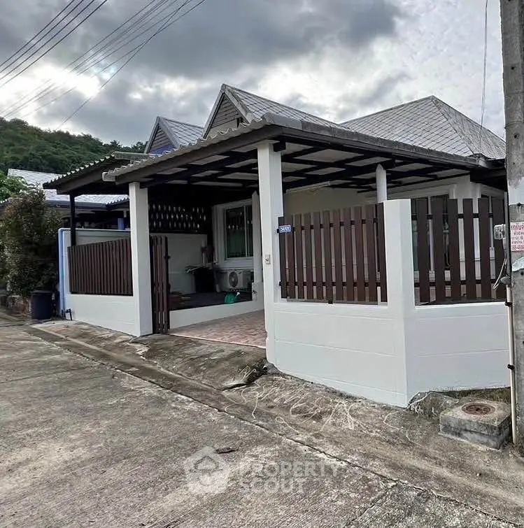 Charming single-story home with fenced yard and mountain backdrop