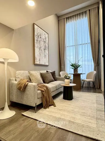 Elegant living room with high ceilings, modern decor, and large window for natural light.