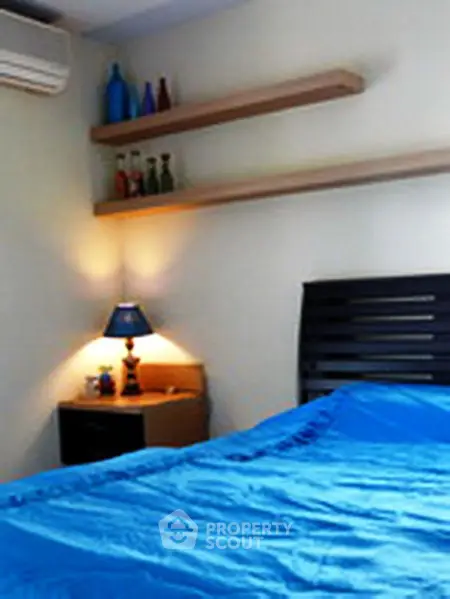 Cozy bedroom with modern decor and blue bedding