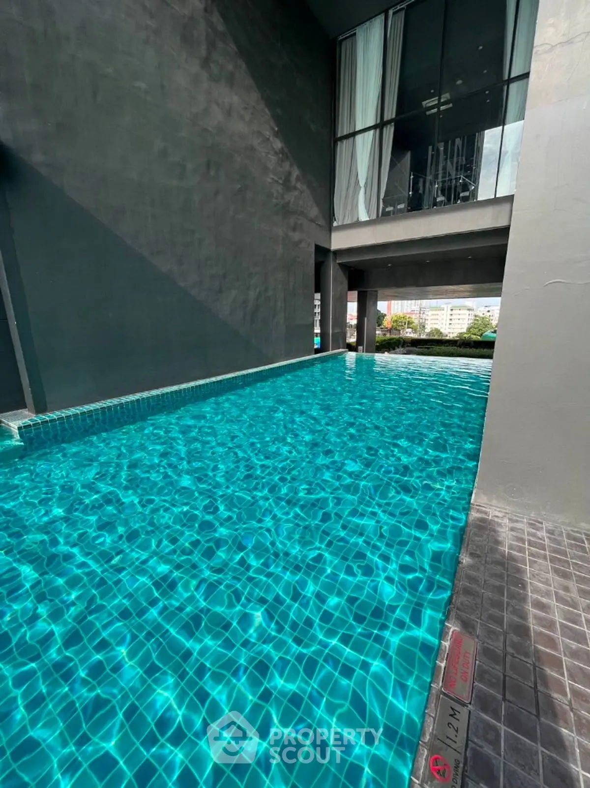 Luxurious modern pool area with stunning architectural design and city view.