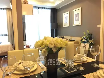 Elegant dining area with floral centerpiece and cozy living room in modern apartment