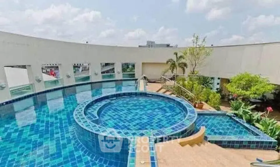 Stunning rooftop pool with panoramic city views and lush greenery