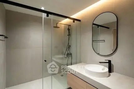 Modern bathroom with glass shower and sleek vanity