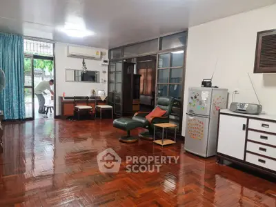 Spacious living room with polished wooden floors and modern furniture