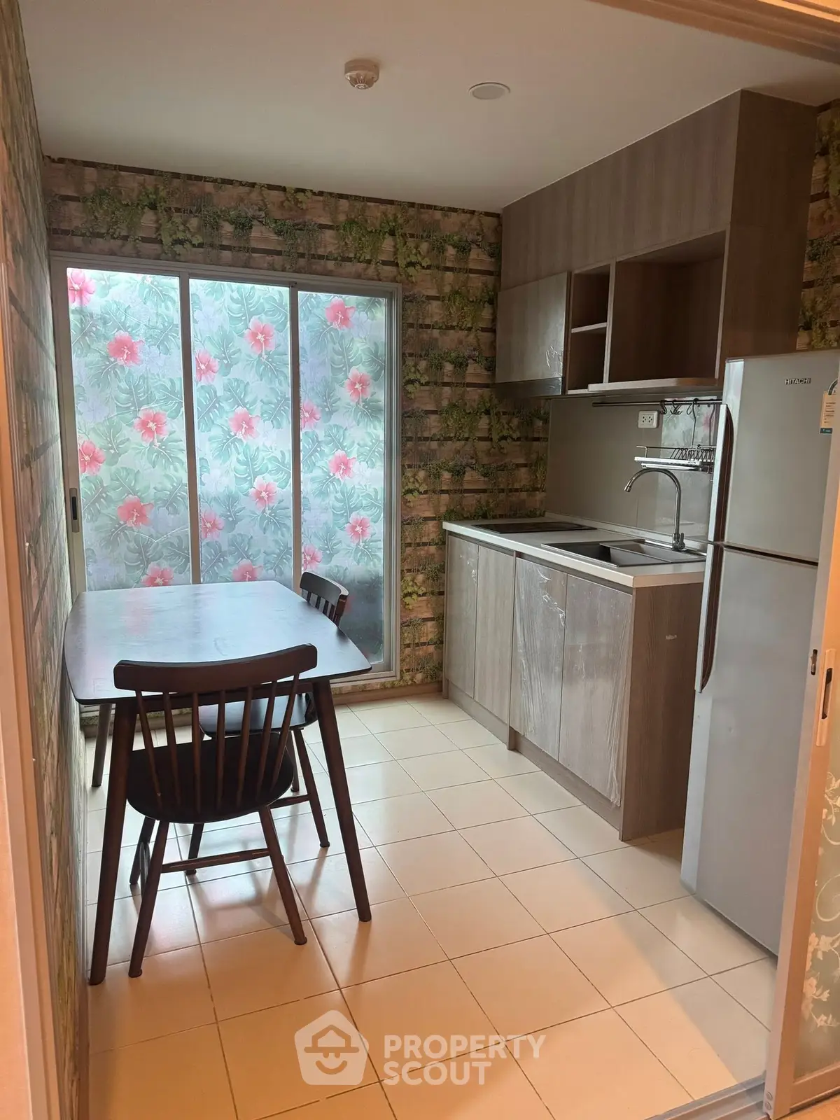 Cozy kitchen with floral wallpaper and modern cabinetry
