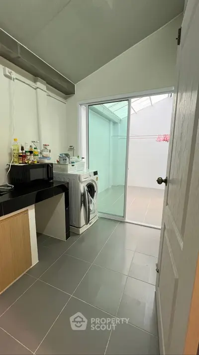 Modern kitchen with sleek design and tiled flooring