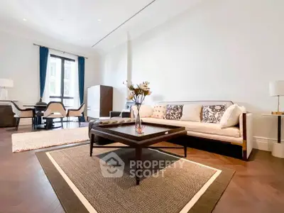 Elegant living room with modern furniture and large windows in a luxury apartment.