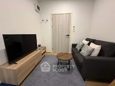 Cozy living room with modern TV setup and comfortable sofa, perfect for relaxation.