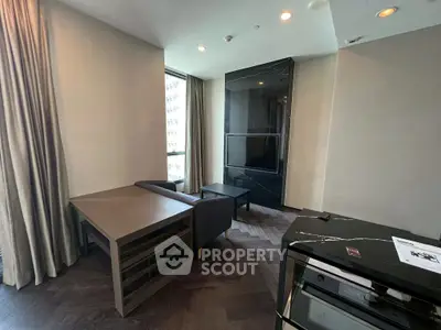 Modern living room with sleek furniture and large windows in a contemporary apartment.