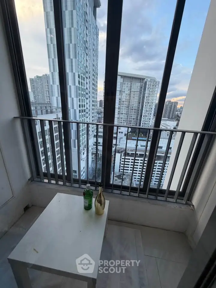 Stunning city view from a modern high-rise balcony with sleek glass railing.