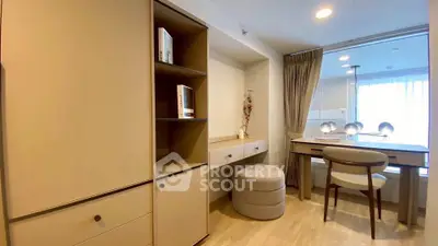 Modern study room with elegant desk and chair, featuring built-in shelves and soft lighting.
