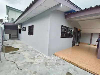 Spacious single-story home with tiled patio and modern exterior design.