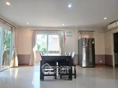 Spacious dining area with natural light and modern decor in a stylish home.