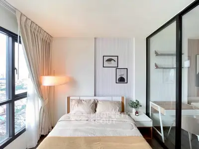 Modern bedroom with city view, stylish decor, and cozy ambiance