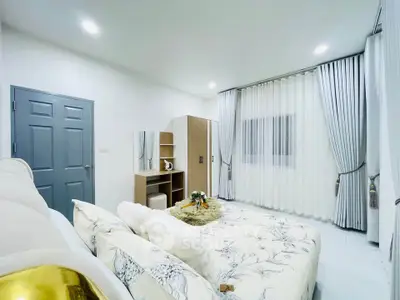 Elegant bedroom with modern decor and ample natural light