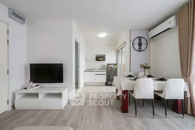 Modern open-plan living room with dining area and sleek kitchen design