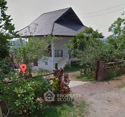 Charming countryside house with lush garden and traditional architecture, perfect for serene living.