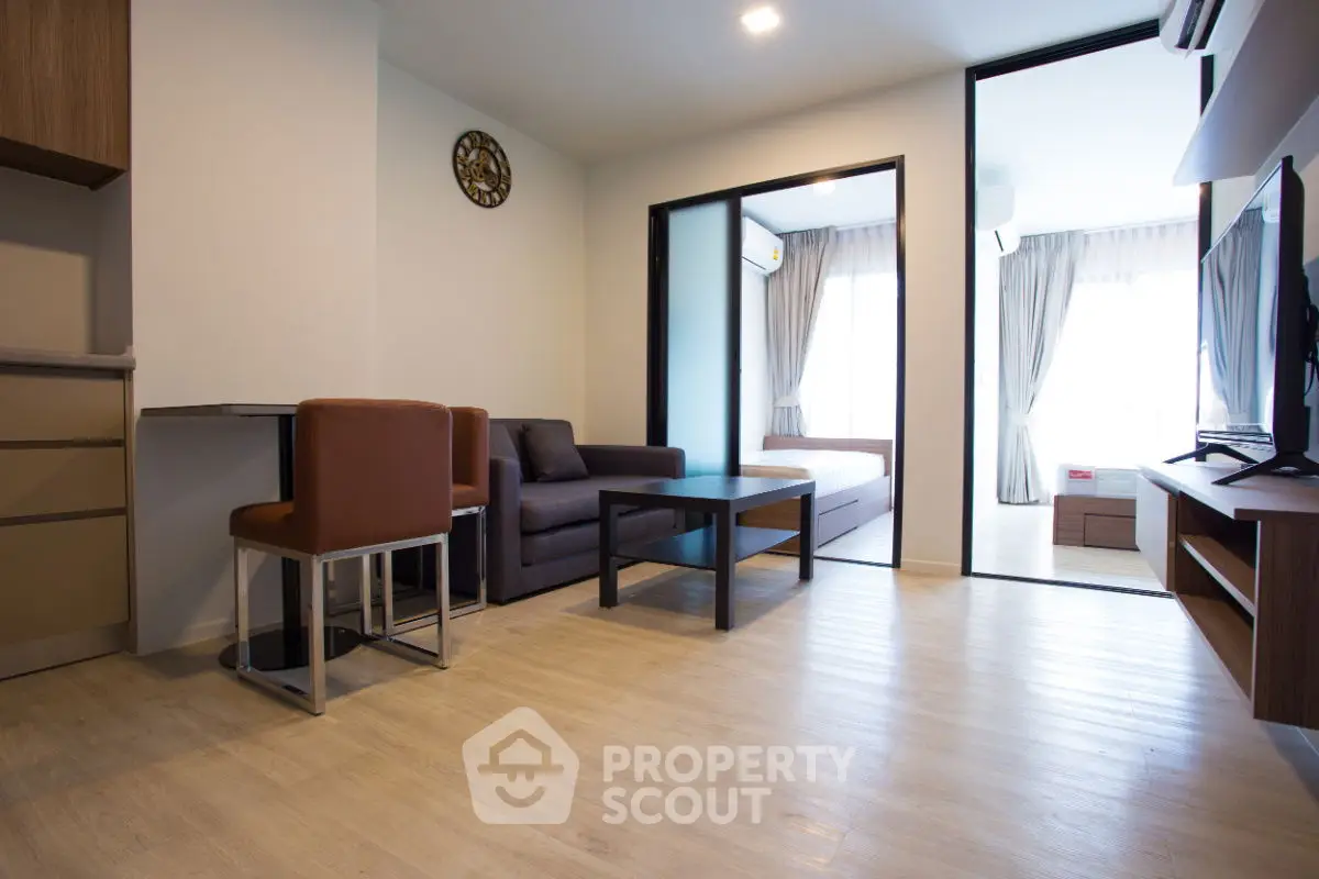 Modern living room with open layout and stylish furniture in a bright apartment.