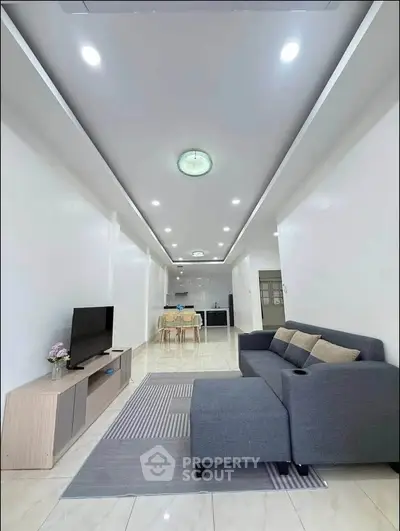 Spacious modern living room with sleek furniture and open kitchen layout