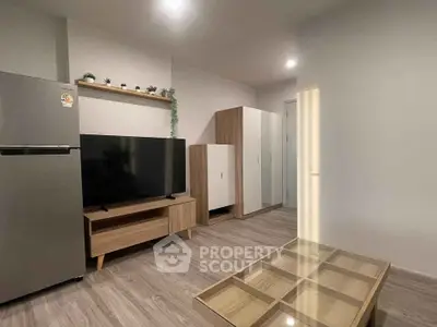 Modern living room with sleek furniture and large TV, perfect for relaxation and entertainment.