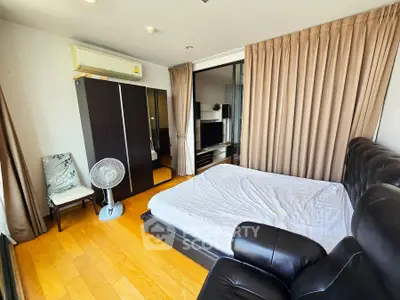 Spacious bedroom with modern furnishings and natural light in a stylish apartment.