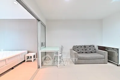 Modern living room with sliding glass doors and cozy furniture in a stylish apartment.