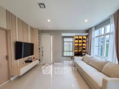 Modern living room with sleek design and large windows for natural light.