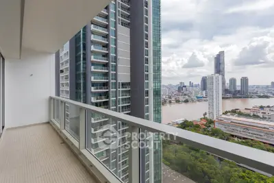 Spacious balcony with stunning city and river views in modern high-rise building.