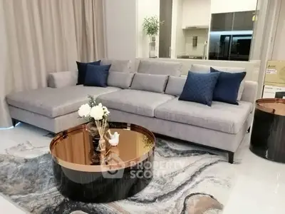 Modern living room with stylish gray sofa and elegant coffee table